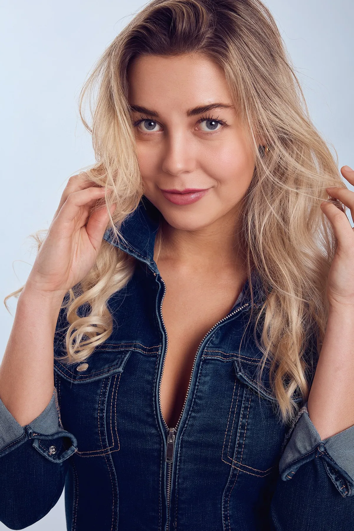 Portrait of a blonde woman in a denim jacket
