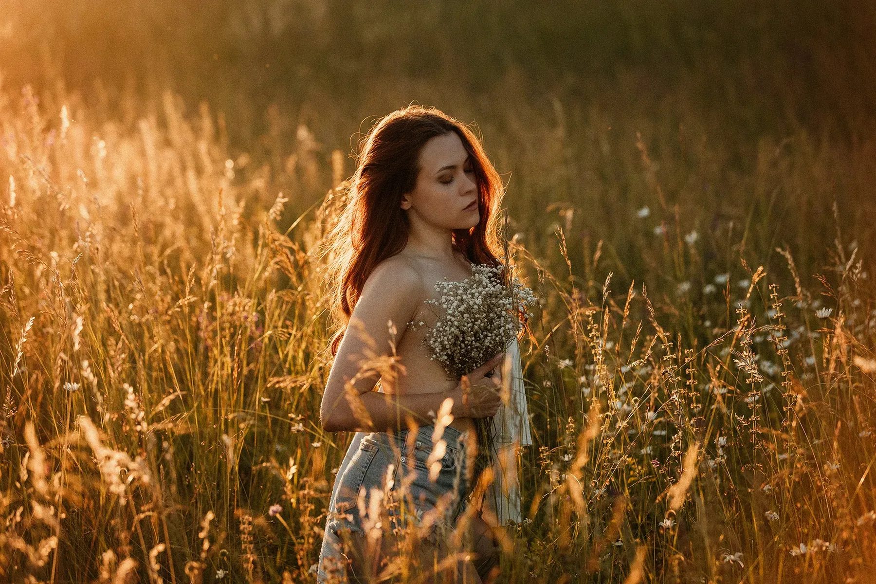 Woman in tall grass in the golden evening light
